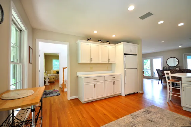 a open kitchen with white cabinets and stainless steel appliances
