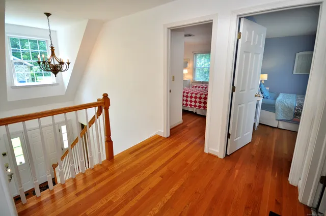 a view of a hallway view with wooden floor and stairs