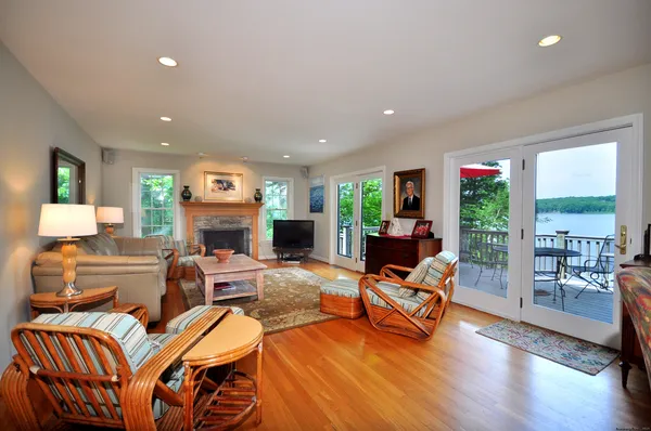 a living room with fireplace furniture and a large window