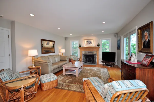 a living room with furniture a fireplace and a flat screen tv