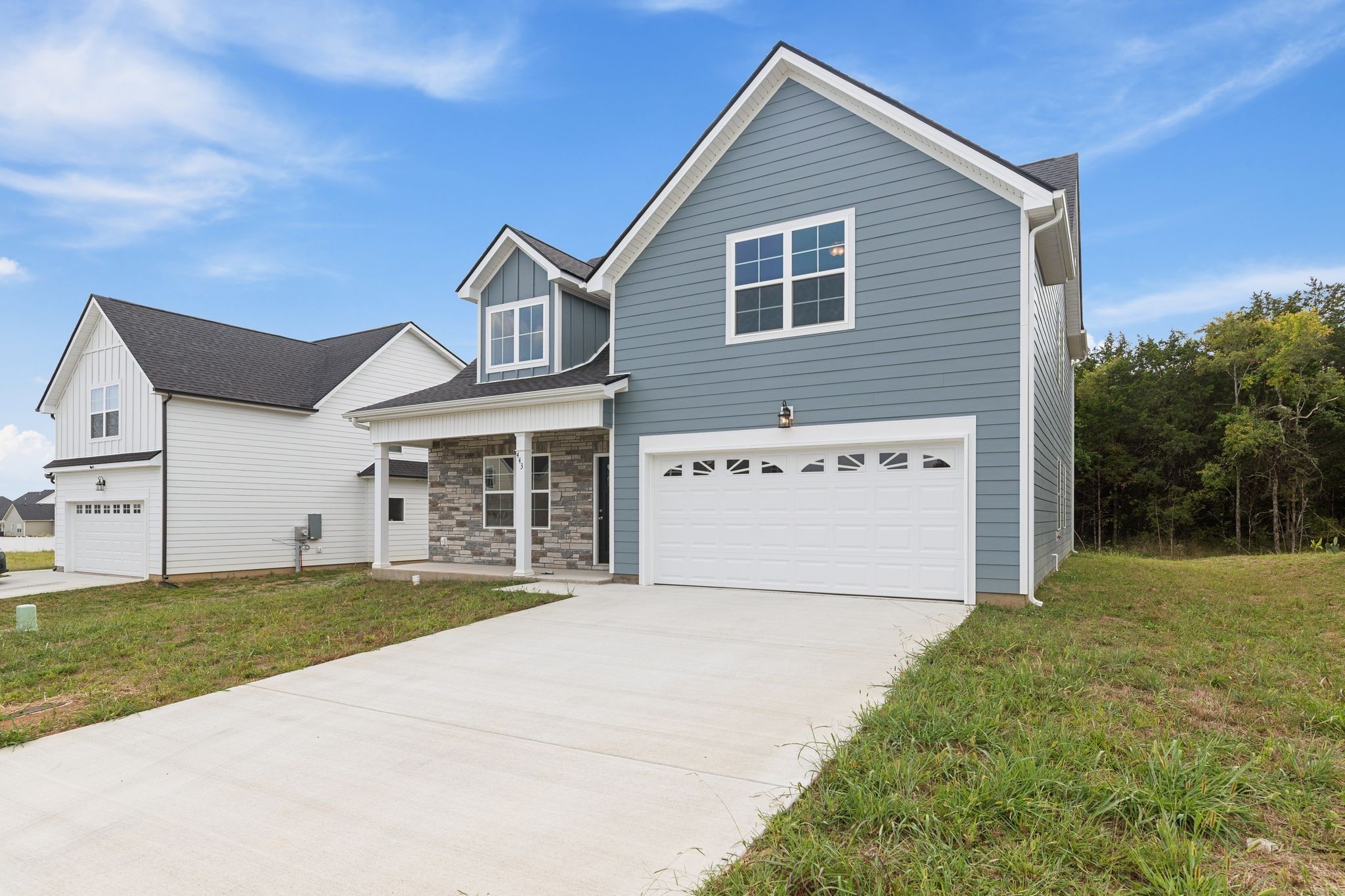 a view of a house with a yard and garage