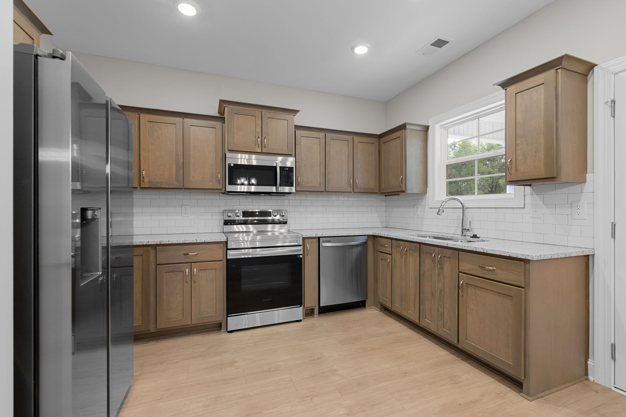 443 Generosity Way Smyrna, TN 37167 - Photo 11 of 37 a kitchen with stainless steel appliances granite countertop a refrigerator sink and stove