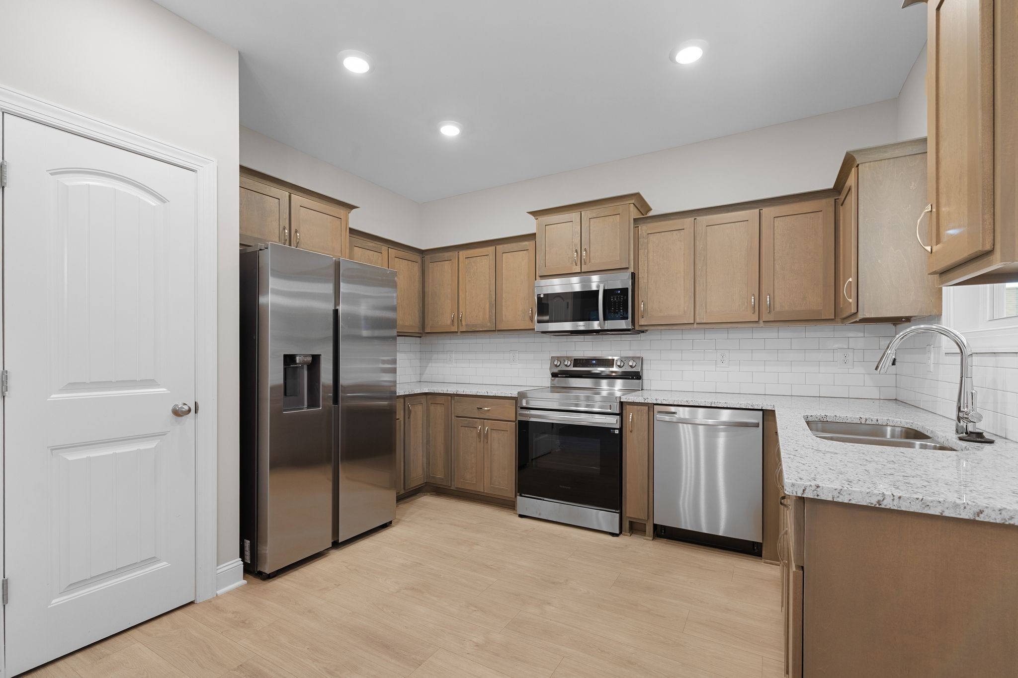 443 Generosity Way Smyrna, TN 37167 - Photo 12 of 37 a kitchen with stainless steel appliances granite countertop a refrigerator stove and sink