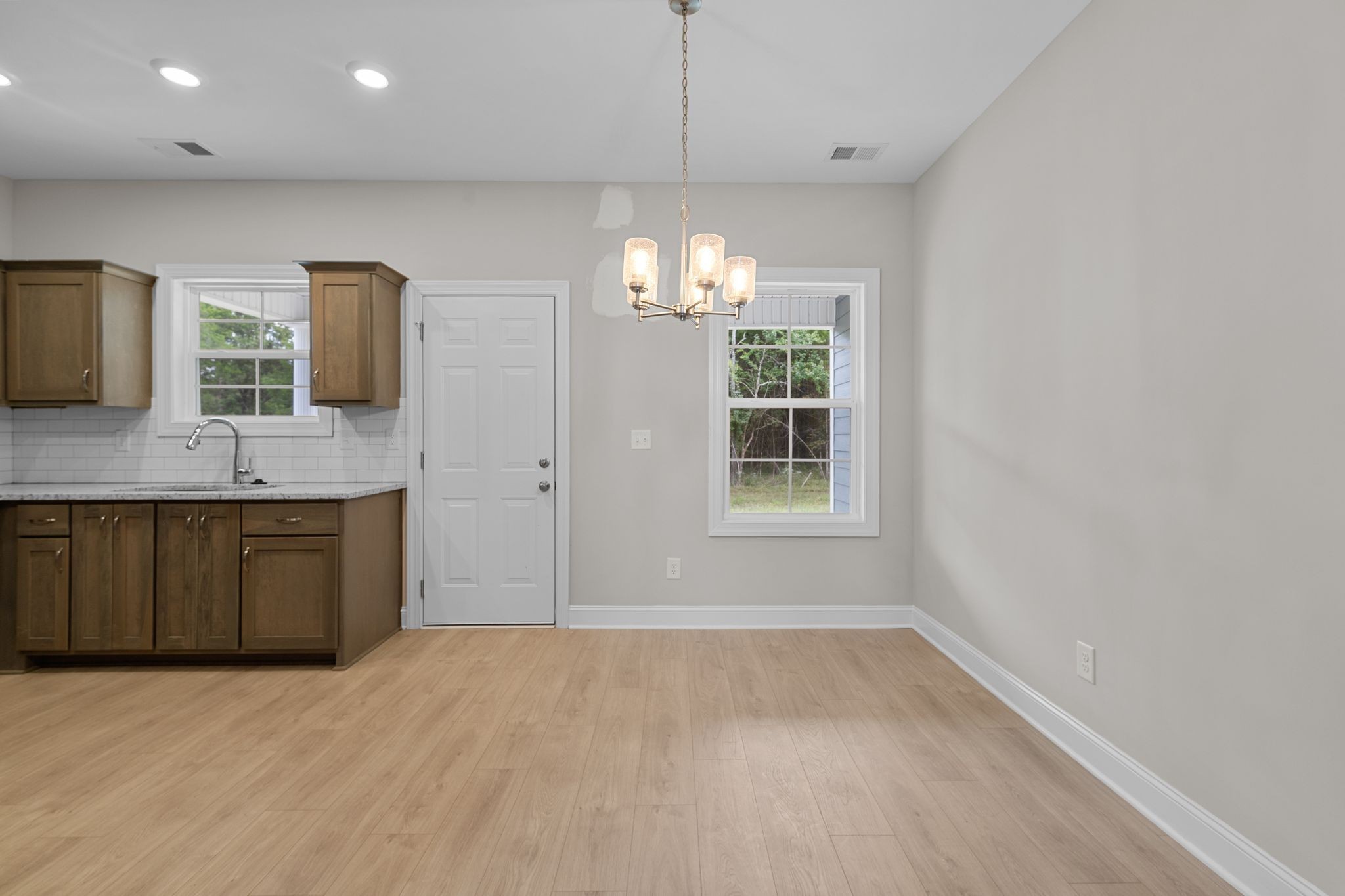 443 Generosity Way Smyrna, TN 37167 - Photo 10 of 37 a kitchen with a sink and chandelier