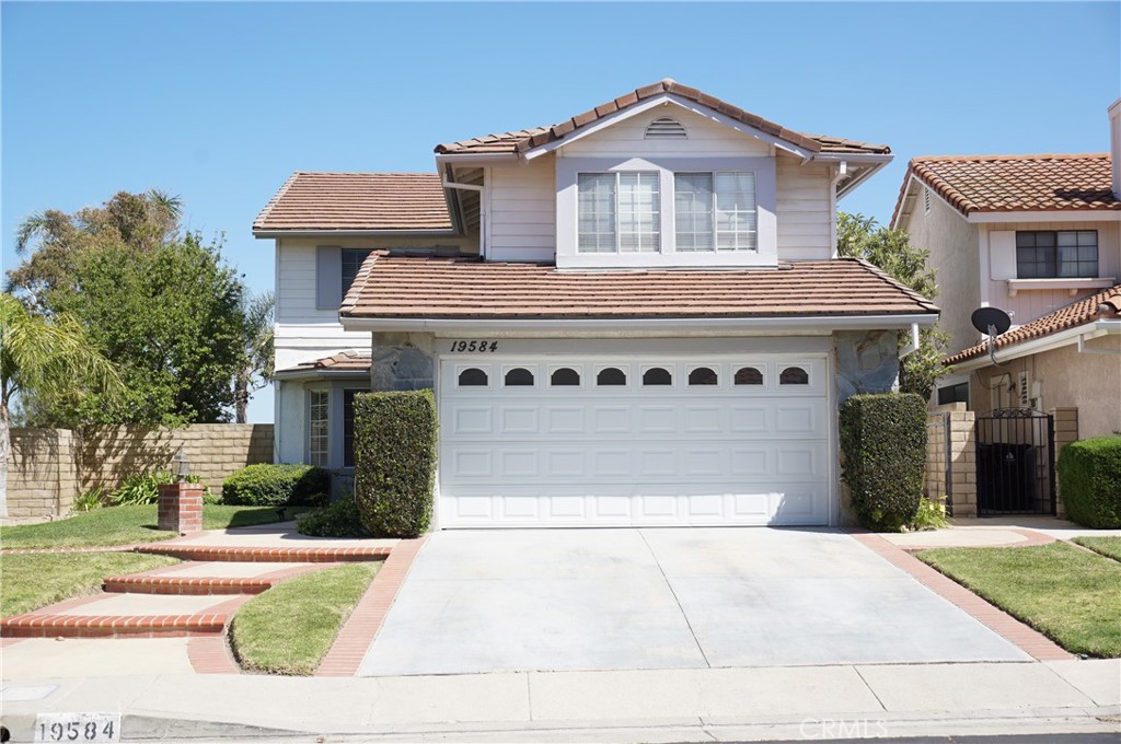 19584 Shadow Glen Circle Porter Ranch, CA 91326 - Photo 2 of 72 a front view of a house with a yard and garage