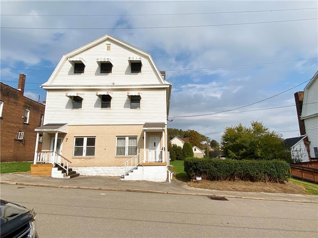 7 Main Street Lyndora, PA 16045 - Photo 2 of 25 a view of a white house with a yard and plants