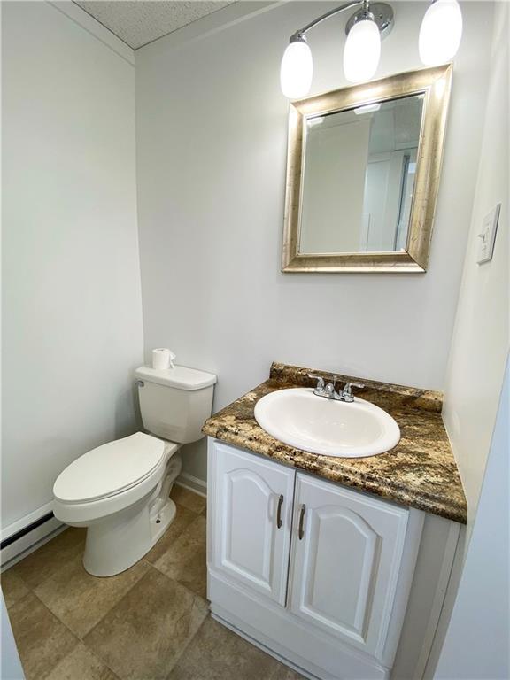 7 Main Street Lyndora, PA 16045 - Photo 18 of 25 a bathroom with a granite countertop toilet sink and mirror