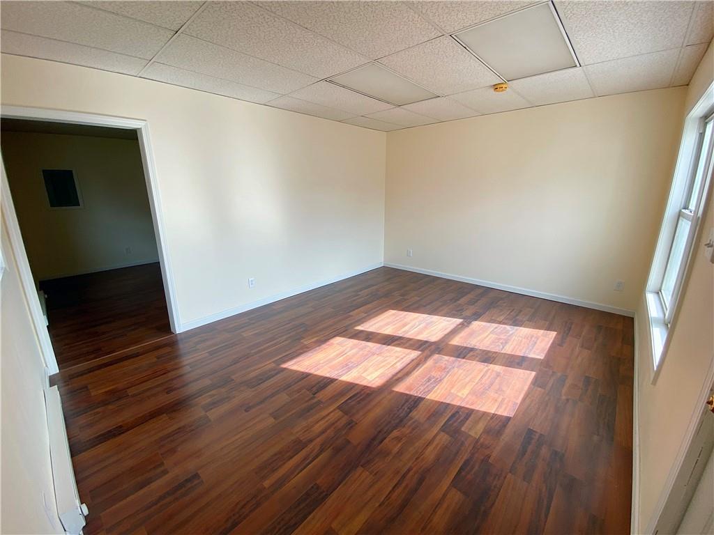 7 Main Street Lyndora, PA 16045 - Photo 4 of 25 an empty room with wooden floor and windows