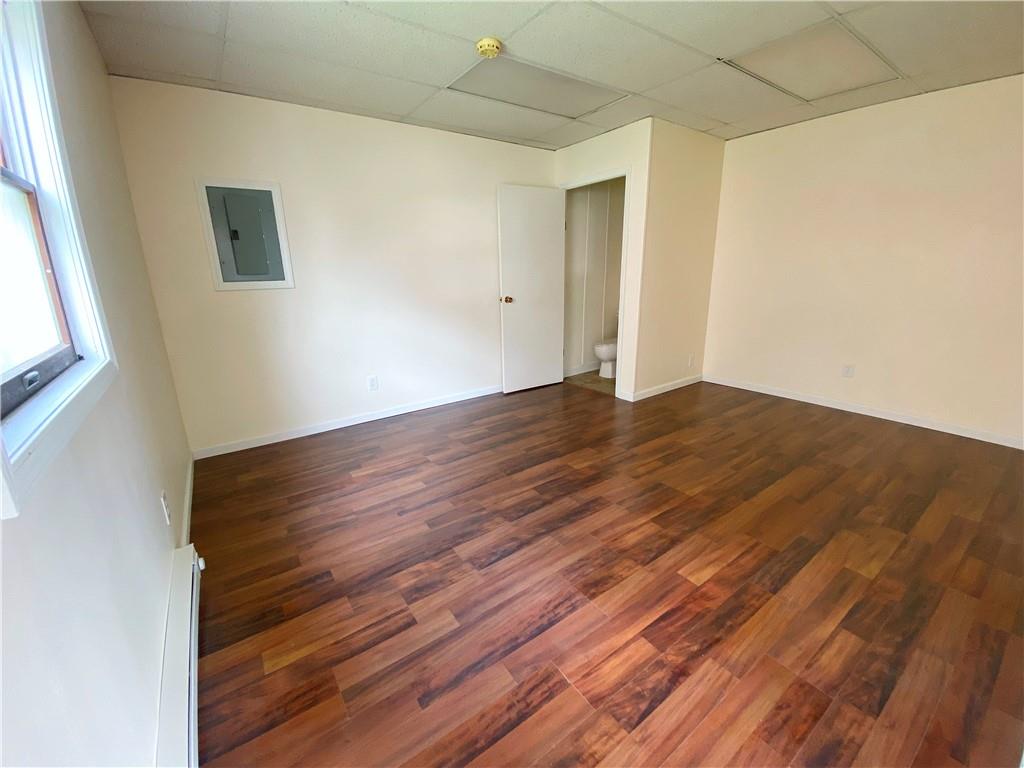 7 Main Street Lyndora, PA 16045 - Photo 6 of 25 a view of an empty room with wooden floor and a window