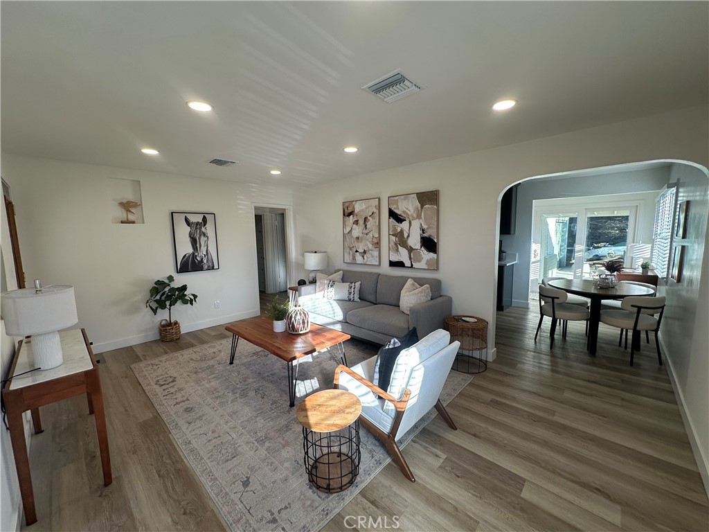 6401 Day Street Tujunga, CA 91042 - Photo 15 of 33 a living room with couches chairs and a dining table with wooden floor