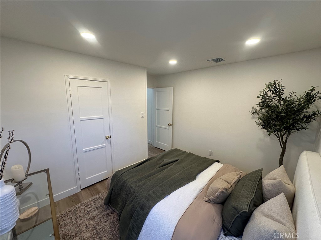 6401 Day Street Tujunga, CA 91042 - Photo 25 of 33 a bedroom with a bed and a potted plant