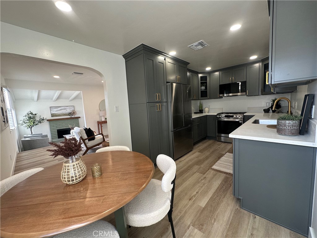 6401 Day Street Tujunga, CA 91042 - Photo 28 of 33 a kitchen with stainless steel appliances granite countertop sink stove top oven and refrigerator