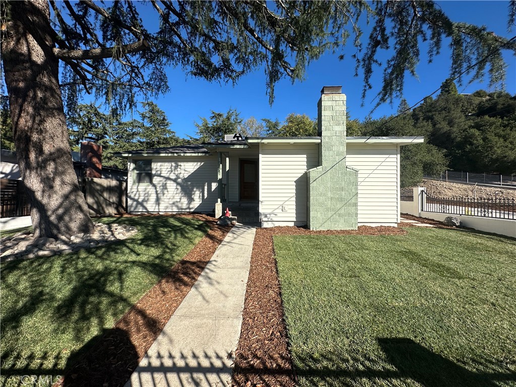 6401 Day Street Tujunga, CA 91042 - Photo 3 of 33 a front view of a house with garden