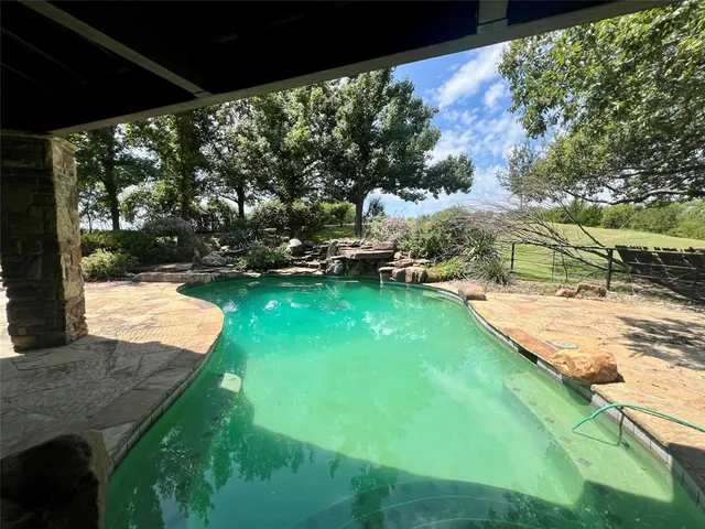 a view of yard with swimming pool