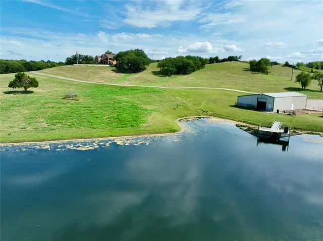 a view of a lake with lawn chairs