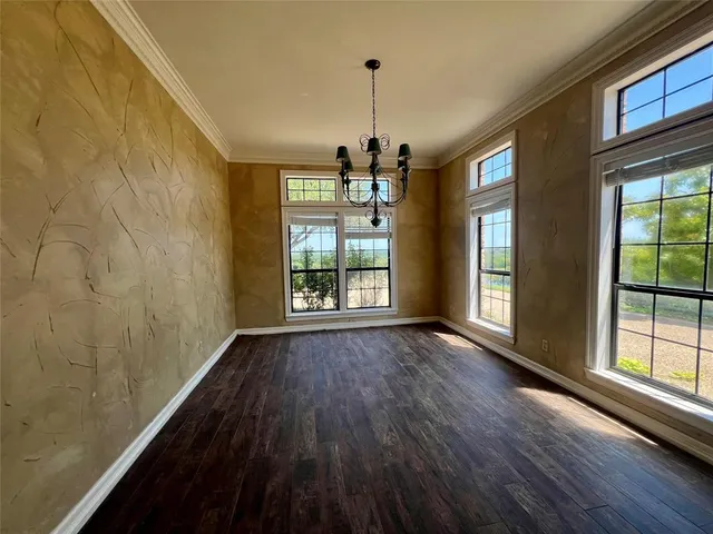 a view of a room window and wooden floor