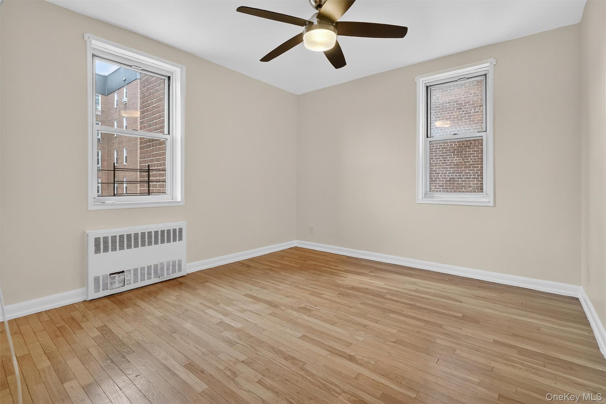 4 Sadore Lane, Unit 4U Yonkers, NY 10710 - Photo 13 of 22 a view of an empty room with wooden floor and a window