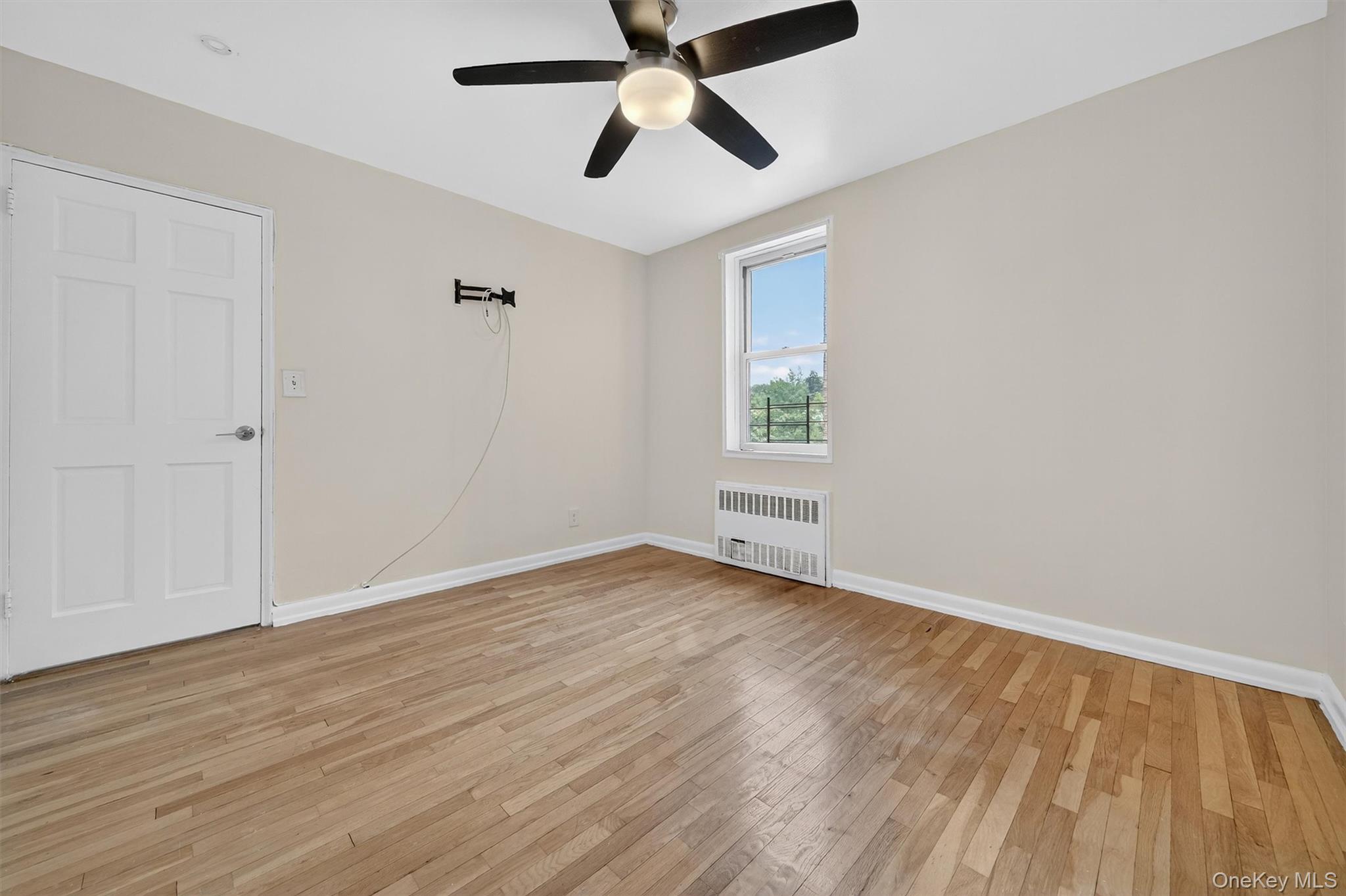 4 Sadore Lane, Unit 4U Yonkers, NY 10710 - Photo 14 of 22 wooden floor in an empty room with a window