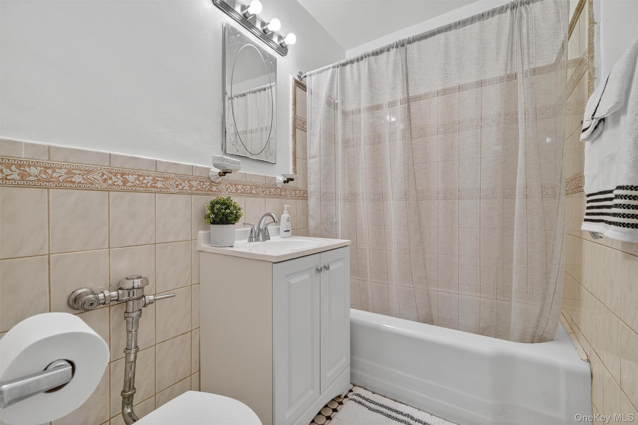 4 Sadore Lane, Unit 4U Yonkers, NY 10710 - Photo 15 of 22 a bathroom with a sink a toilet and shower curtain