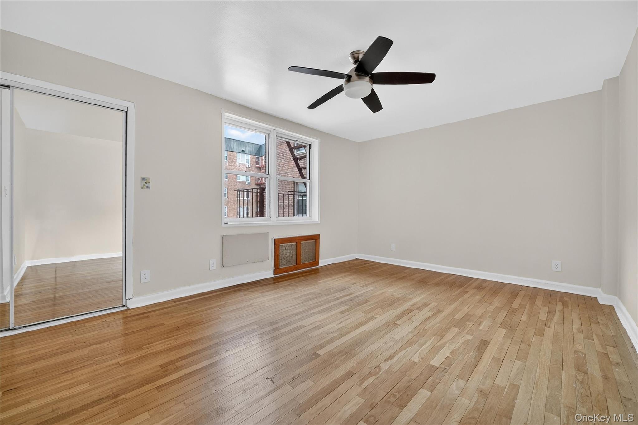4 Sadore Lane, Unit 4U Yonkers, NY 10710 - Photo 16 of 22 a view of empty room with wooden floor and window