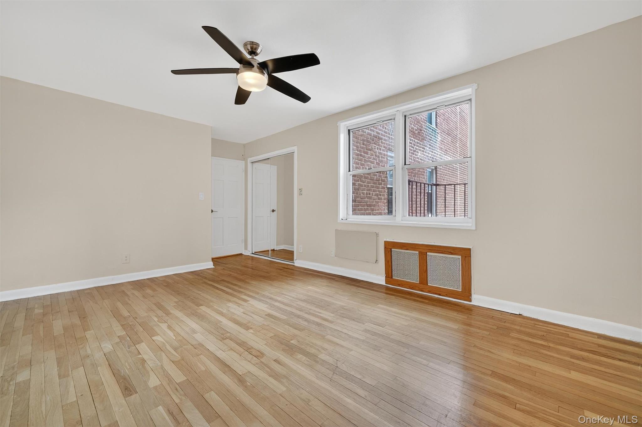 4 Sadore Lane, Unit 4U Yonkers, NY 10710 - Photo 17 of 22 a view of an empty room with wooden floor and a window