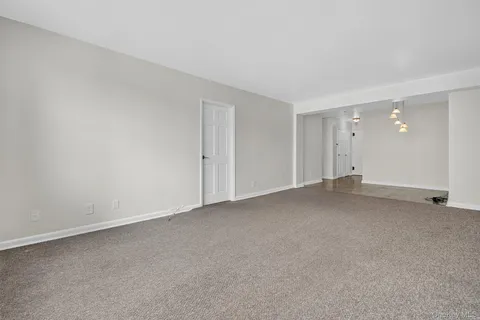 a kitchen with granite countertop white cabinets stainless steel appliances and a sink