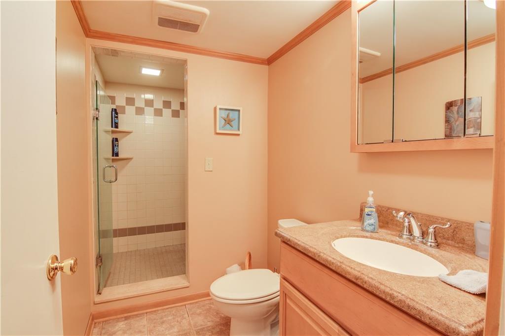 281 McKinney Road Wexford, PA 15090 - Photo 14 of 21 Conveniently located adjacent to the spacious family room, this newly remodeled lower level bath boasts a walk-in ceramic tiled shower, large vanity, and ceramic tiled floors.
