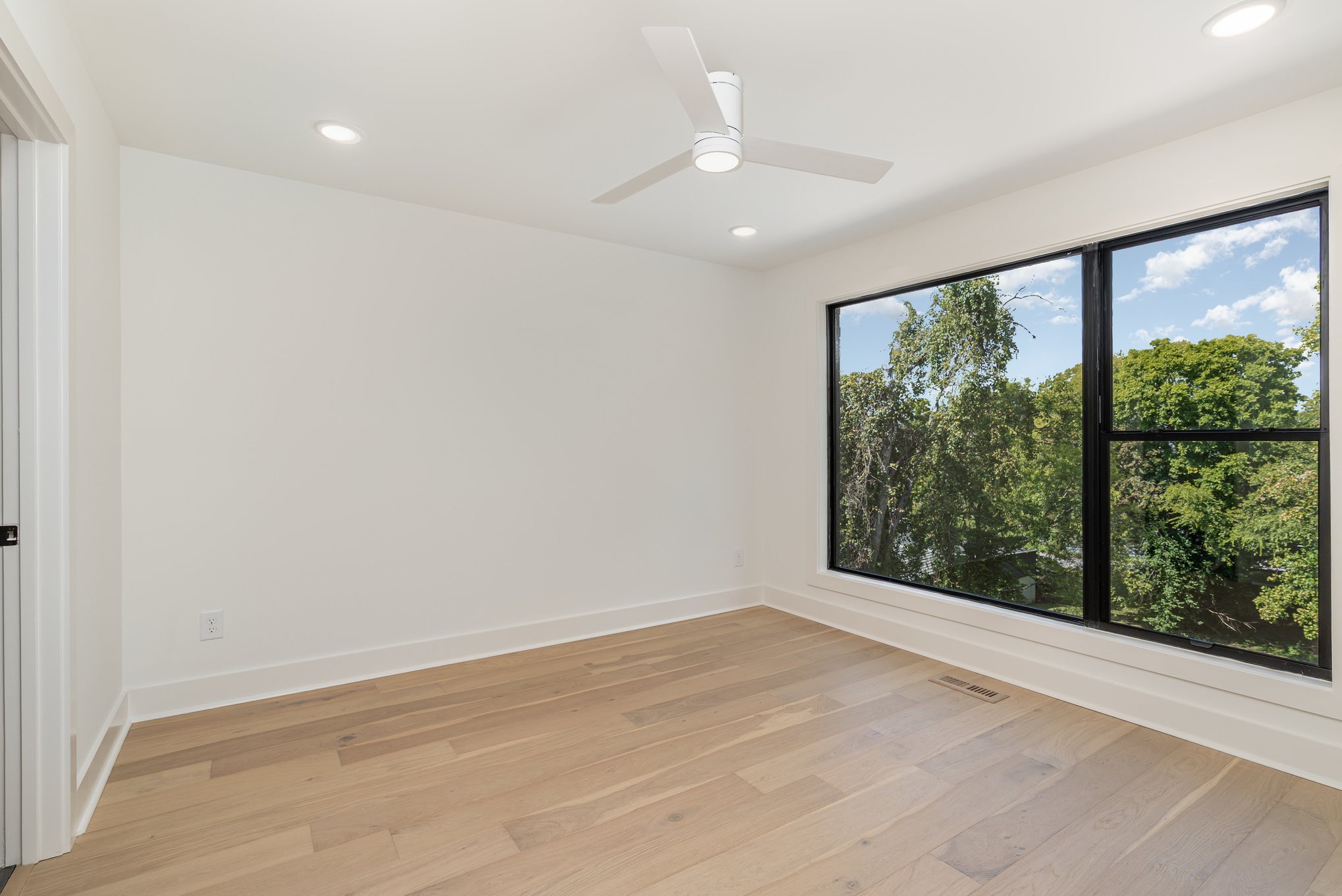 546 A Rosedale Avenue, Unit 15 Nashville, TN 37211 - Photo 18 of 40 an empty room with wooden floor and windows