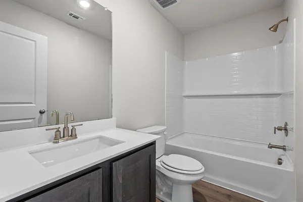 a bathroom with a sink a toilet and a bathtub