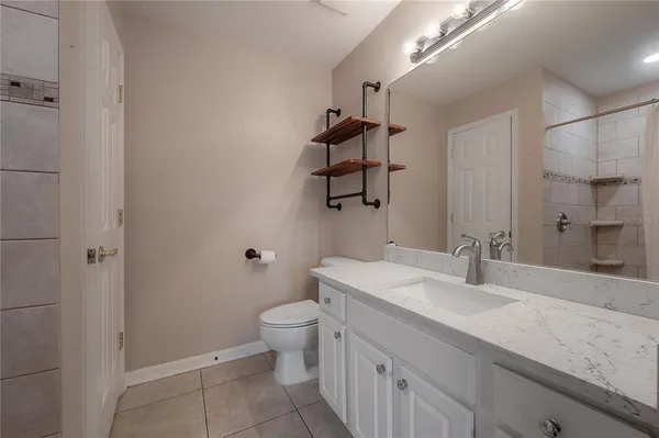 a bathroom with a sink a toilet and mirror