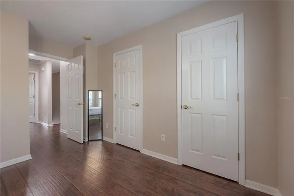 a view of a hallway with wooden floor
