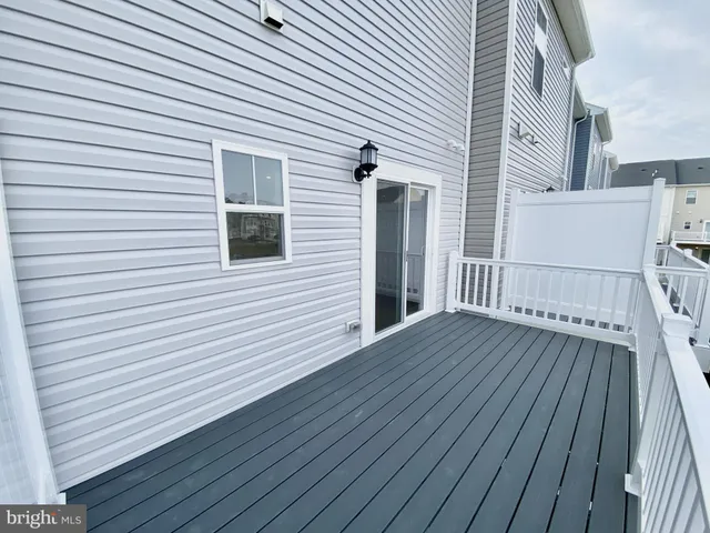 a view of a big house with pool and lawn chairs under an umbrella