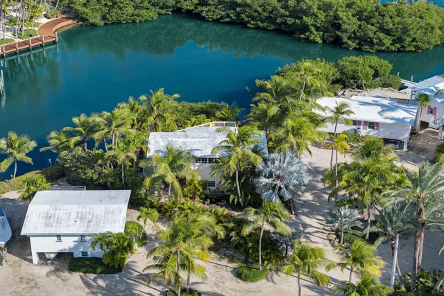 an aerial view of ocean with residential house with outdoor space