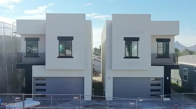 a hallway with couches and a potted plant