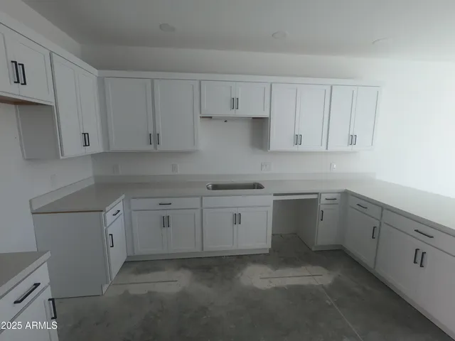 a kitchen with white cabinets