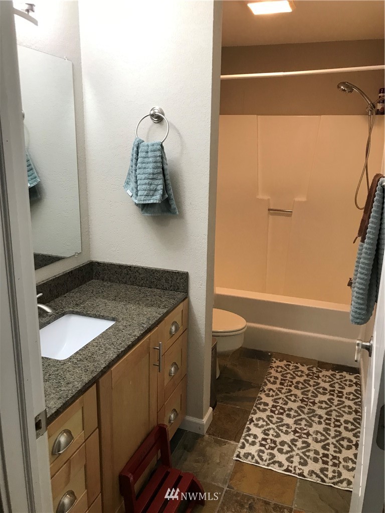 173 River Heights Road Centralia, WA 98531 - Photo 15 of 40 a bathroom with a granite countertop sink toilet and shower