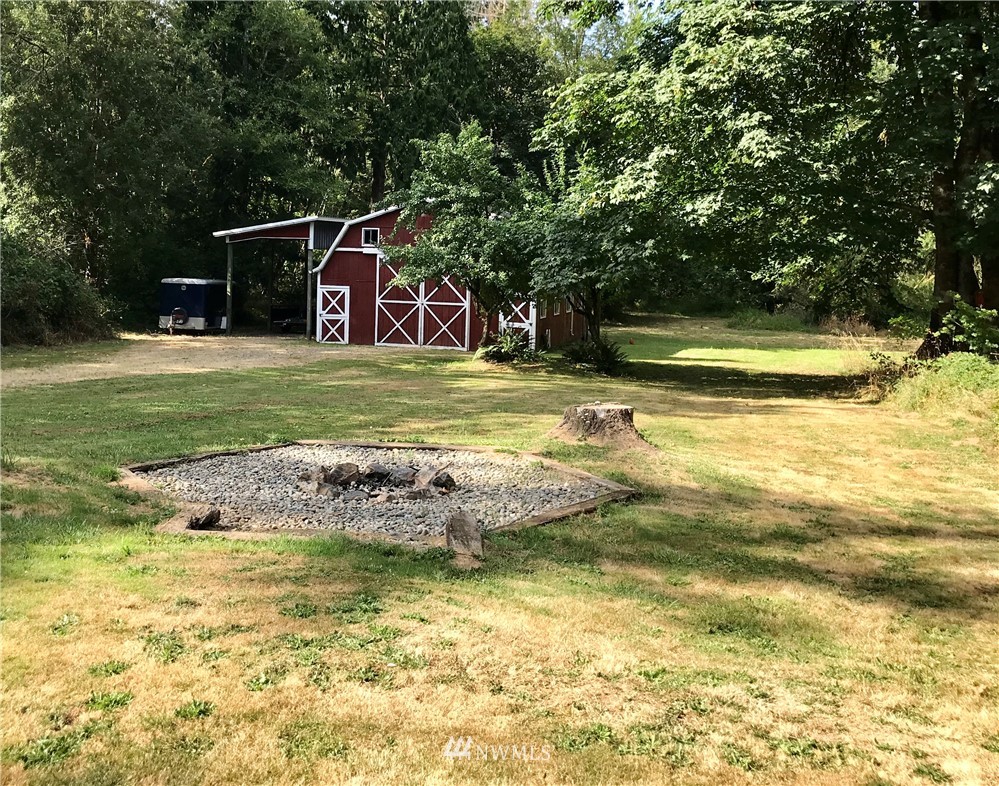 173 River Heights Road Centralia, WA 98531 - Photo 26 of 40 a view of a swimming pool with a garden and trees
