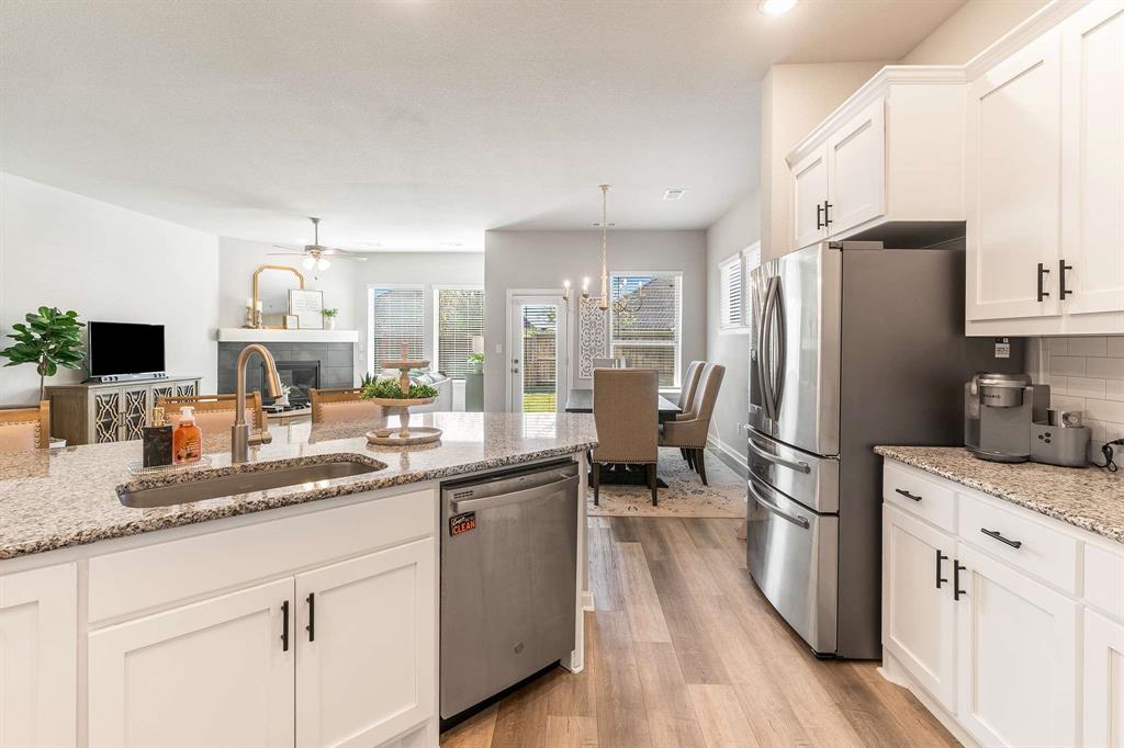 1609 Cotton Road Van Alstyne, TX 75495 - Photo 11 of 27 a kitchen with white cabinets and stainless steel appliances