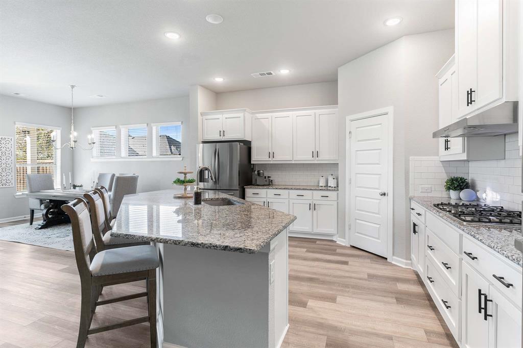 1609 Cotton Road Van Alstyne, TX 75495 - Photo 12 of 27 a kitchen with white cabinets and stainless steel appliances