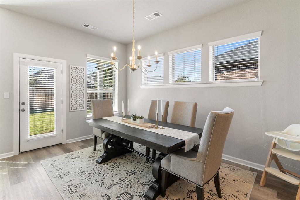 1609 Cotton Road Van Alstyne, TX 75495 - Photo 13 of 27 a view of a dining room with furniture window and wooden floor
