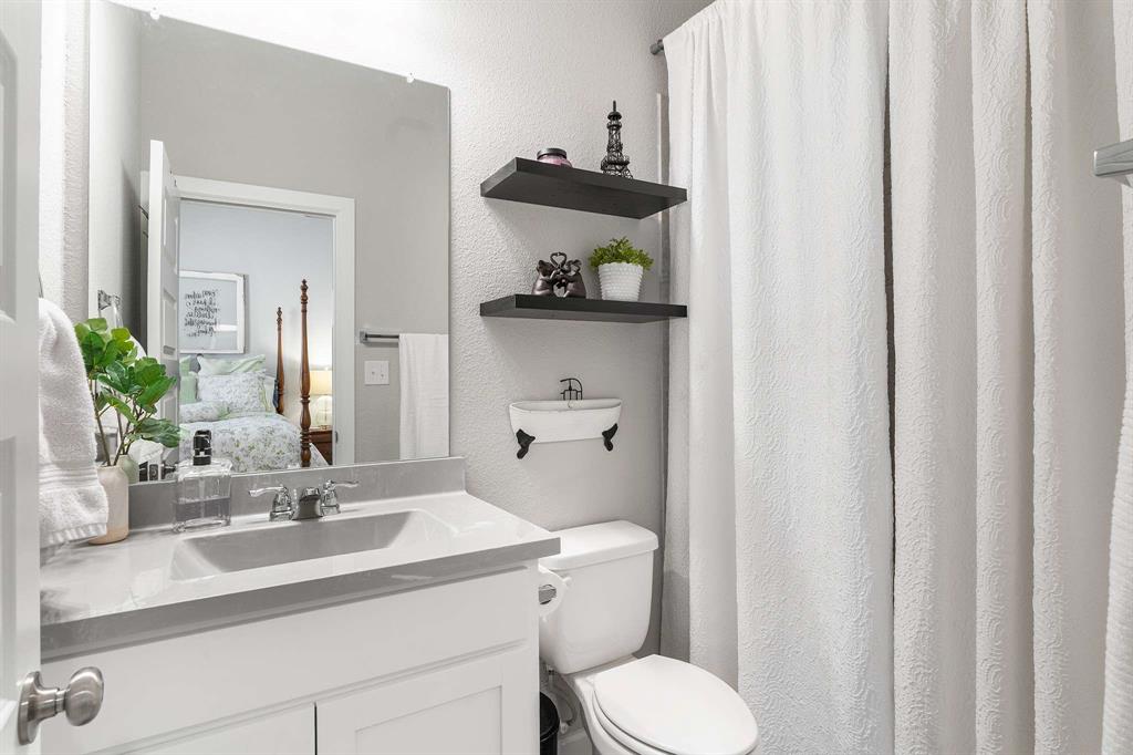 1609 Cotton Road Van Alstyne, TX 75495 - Photo 18 of 27 a bathroom with a sink a toilet and a mirror