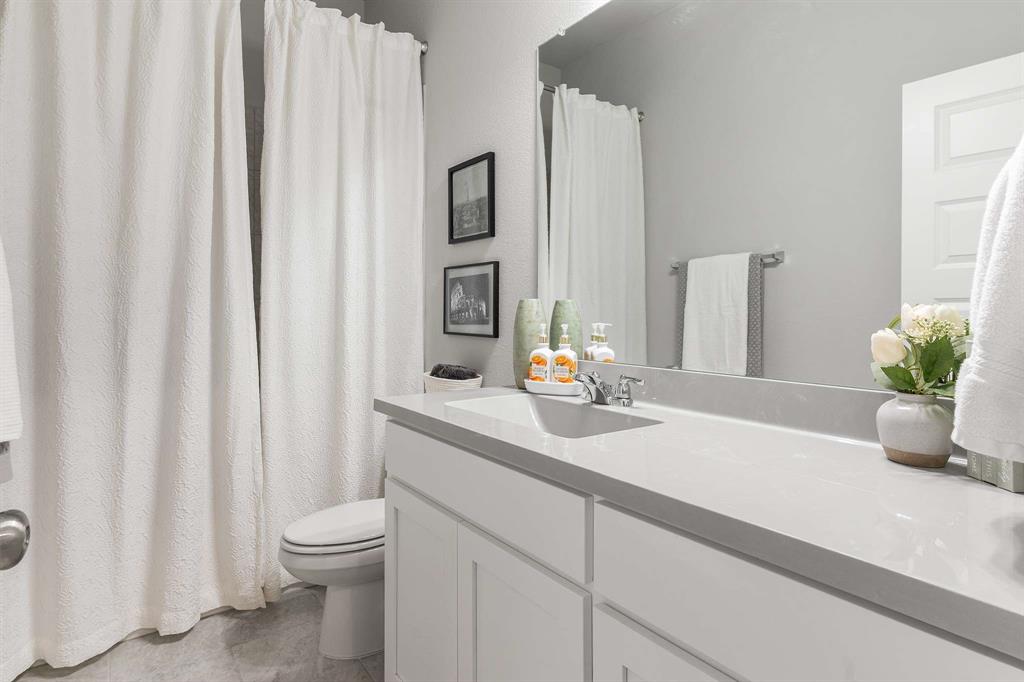 1609 Cotton Road Van Alstyne, TX 75495 - Photo 20 of 27 a bathroom with a sink a toilet and a mirror