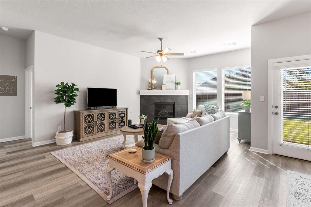 1609 Cotton Road Van Alstyne, TX 75495 - Photo 3 of 27 a living room with furniture a fireplace and a flat screen tv