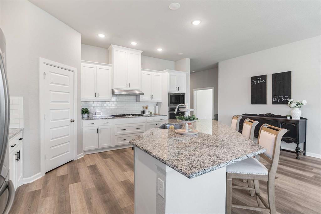 1609 Cotton Road Van Alstyne, TX 75495 - Photo 9 of 27 a kitchen with white cabinets and stainless steel appliances