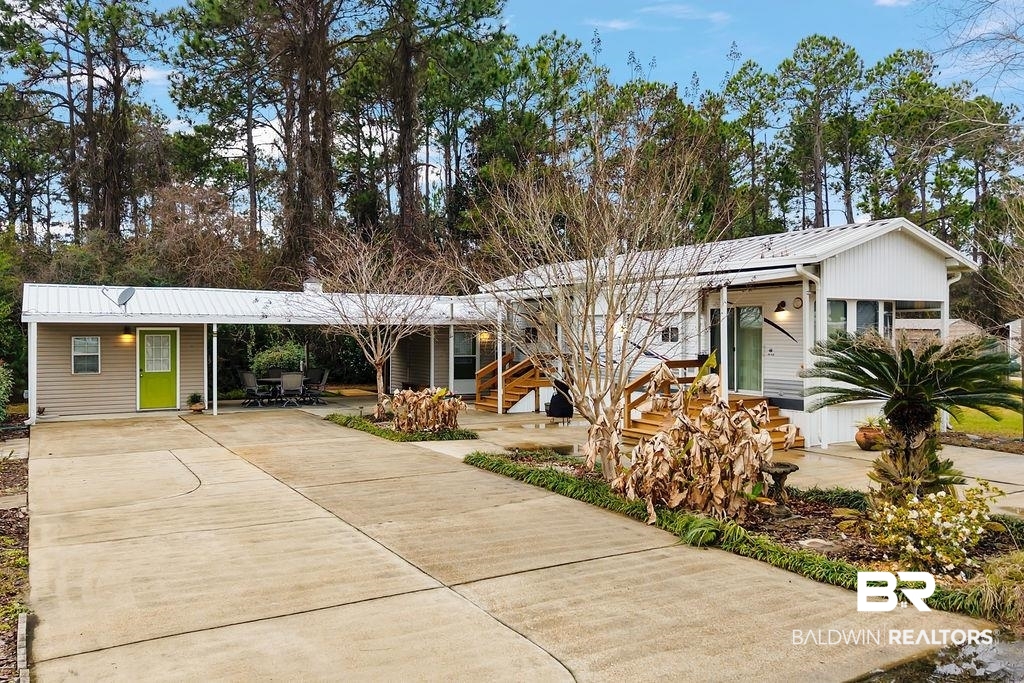 4211 Azalea Street Orange Beach, AL 36561 - Photo 1 of 29 View of front of house featuring a patio area and view of wooded area