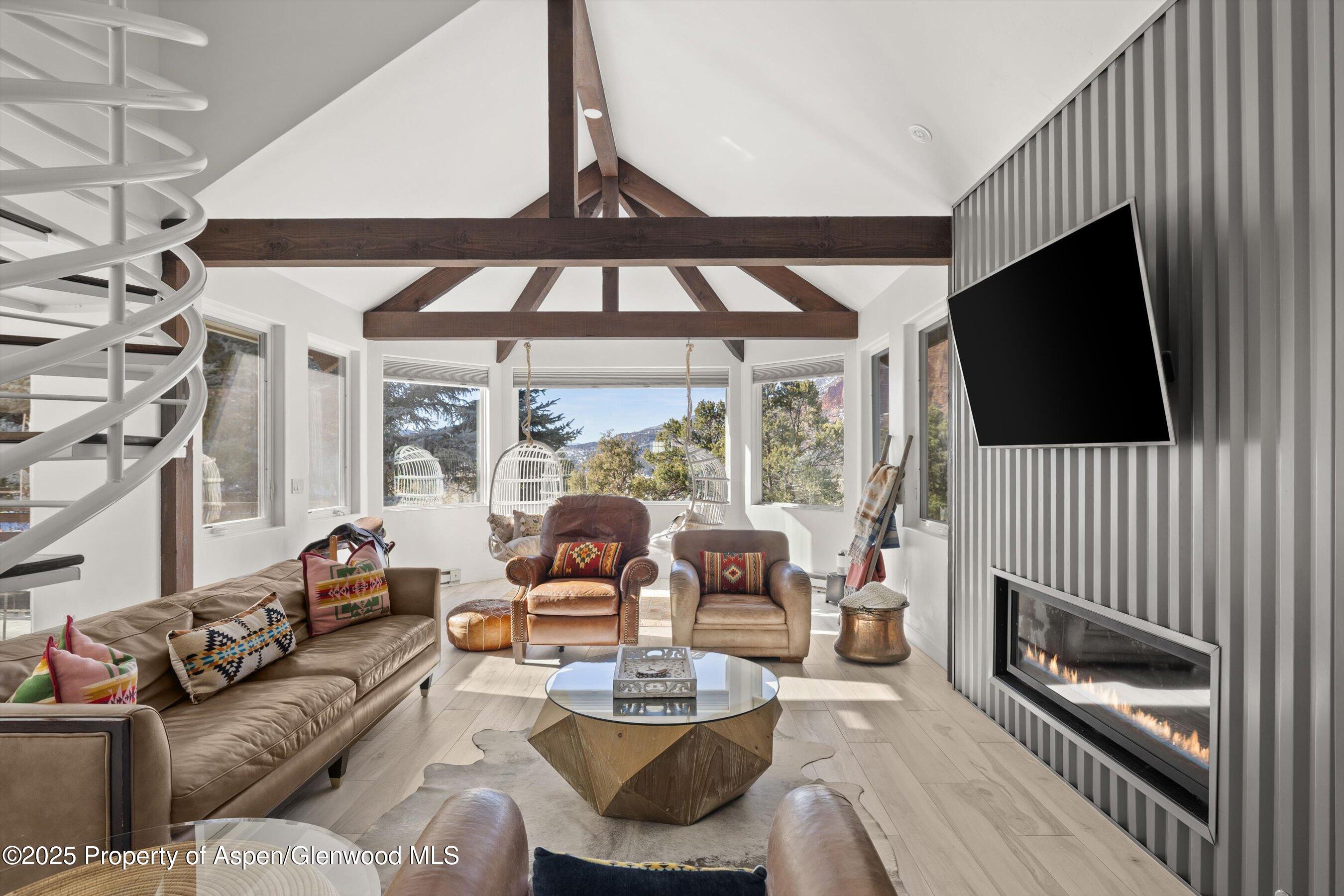a living room with fireplace furniture and a flat screen tv