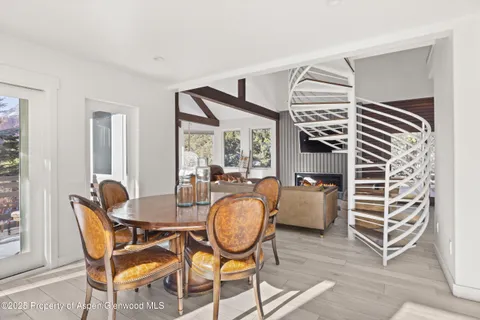 a bedroom with a large bed a potted plant and a window