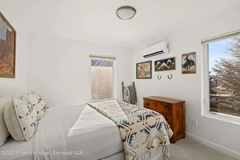 a bedroom with furniture and a window