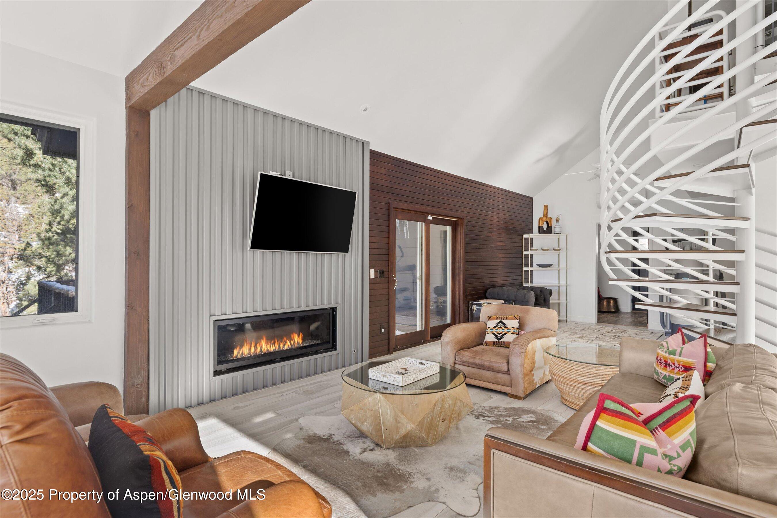 163 Castle Lane Basalt, CO 81621 - Photo 3 of 28 a living room with furniture a fireplace and a flat screen tv