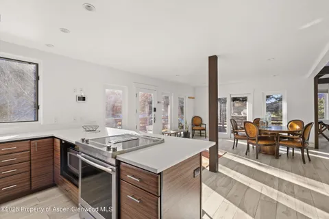 a dining room with furniture and wooden floor